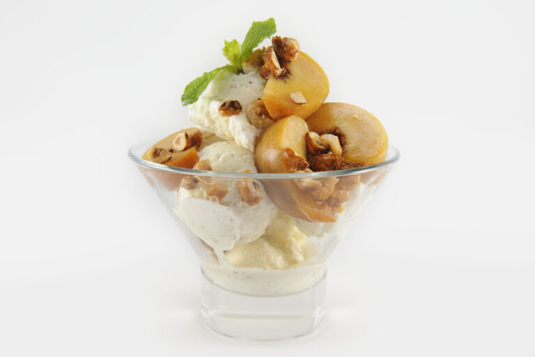 Bourbon Ice Cream topped with Poached Peaches and Hazelnut Crunch